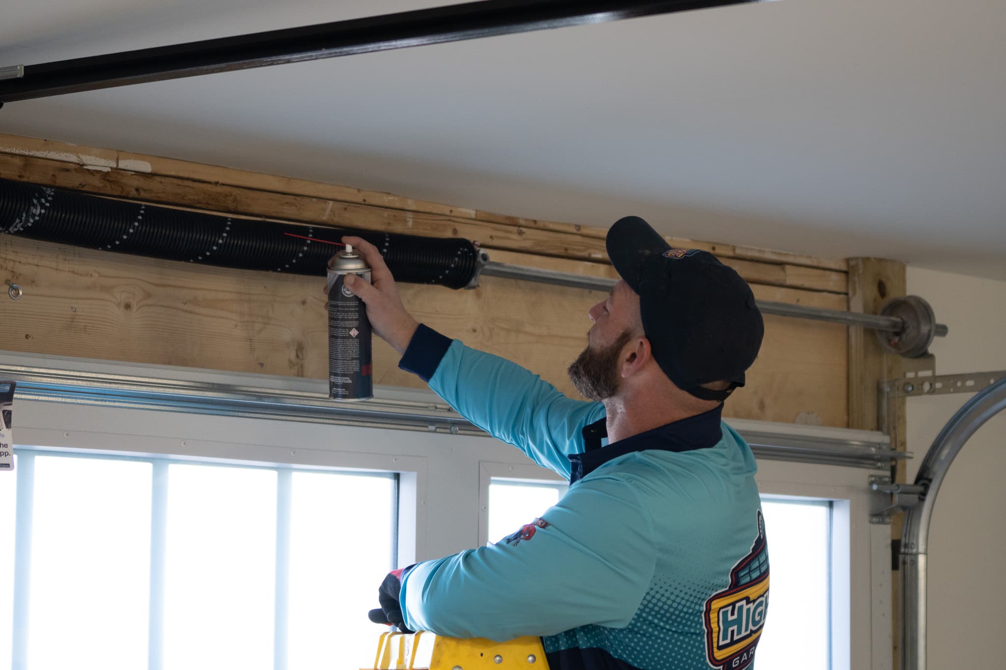 HighLevel technician performing garage door tune-up