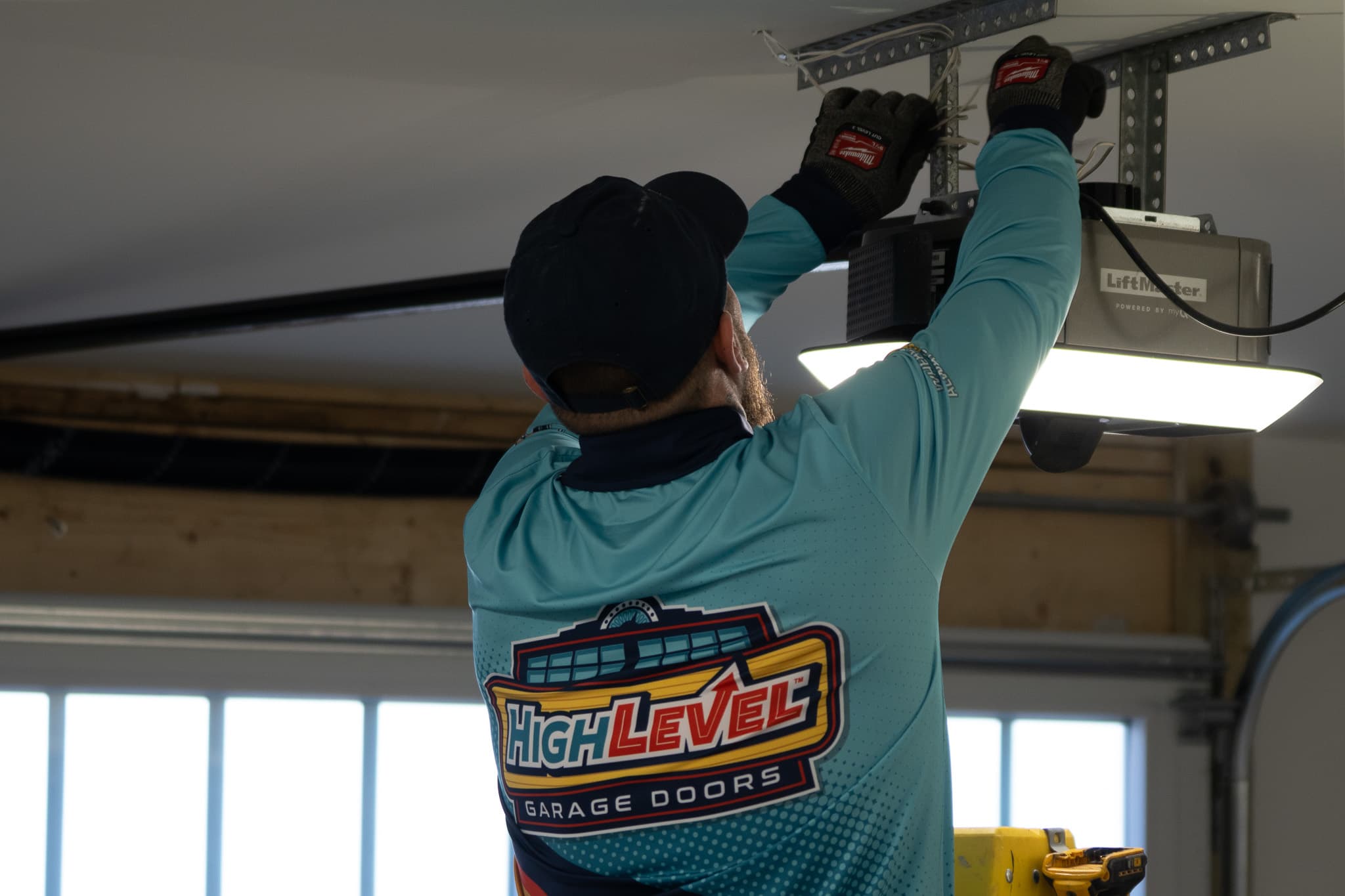 HighLevel technician performing opener installation