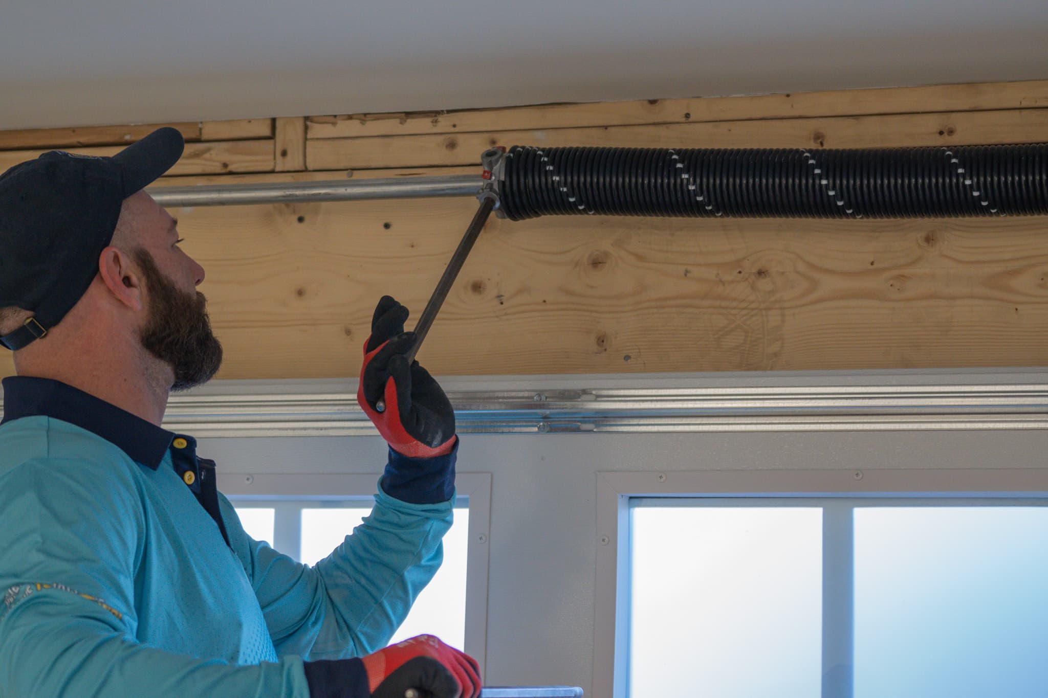 HighLevel technician performing garage door repair